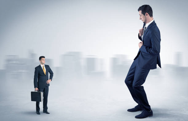 istock Giant businessman is  afraid of small executor 1205289187