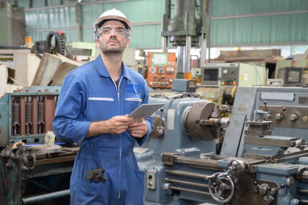 istock Caucasian man in uniform works hold tablet on the production. Industrial modern technology. 1205290539