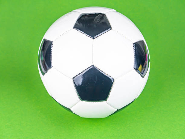 istock Soccer ball on a green background. 1205297241