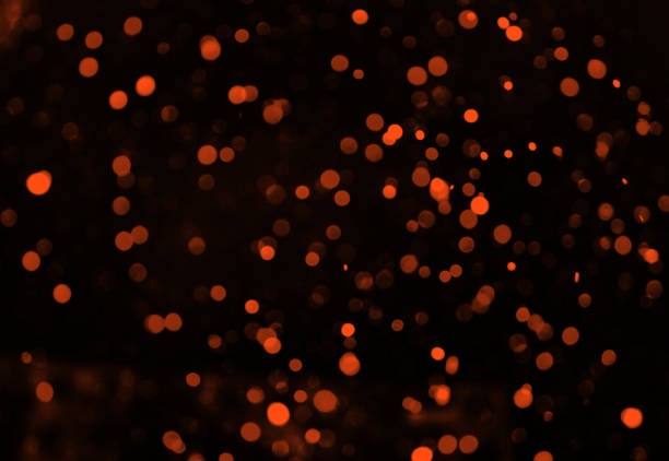 istock bokeh orange circles on a black background design 1205300520