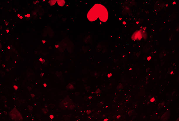 istock bokeh red hearts valentines day, love on black background design 1205300602