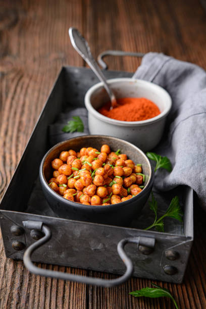 Crunchy snack, crispy and spicy oven roasted chickpea covered in paprika and red chilli powder stock photo