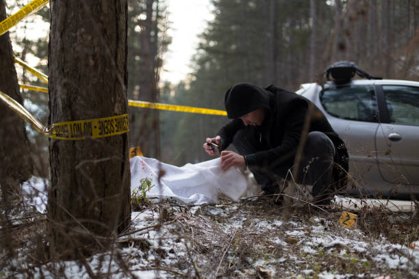 istock Detectives on murder crime scene collecting evidence 1205300862