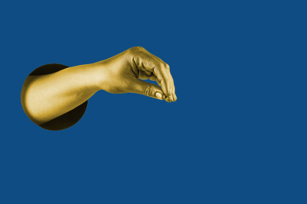 istock Hand painted in gold shows different gestures and symbols from the hole on a blue paper background. Template for design. Trend color of 2020 concept. 1205301521
