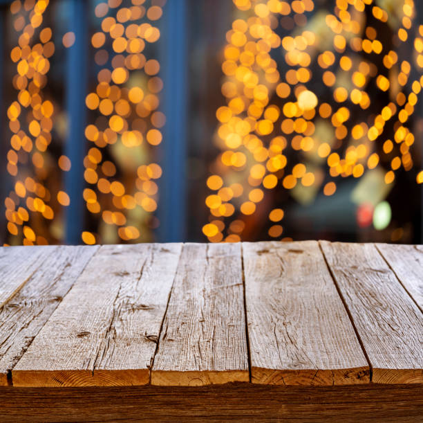 istock Rustic wooden table in party holidays blur lights 1205301547