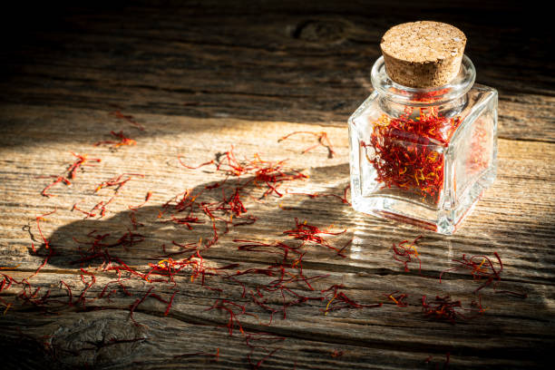 istock Saffron spice in glass bottle on rustic wooden table 1205302562