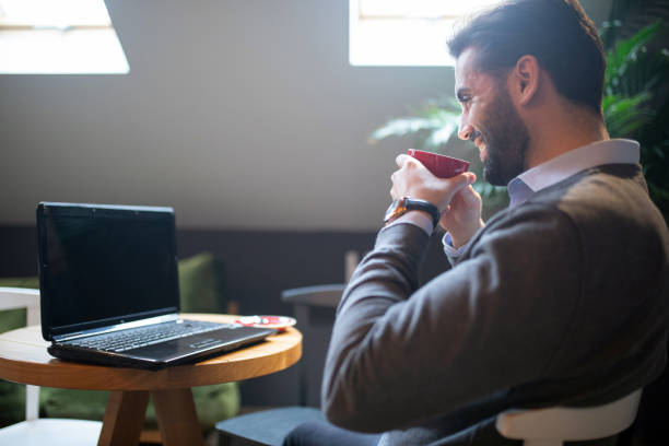 istock Businessman drinking coffee and working 1205302618