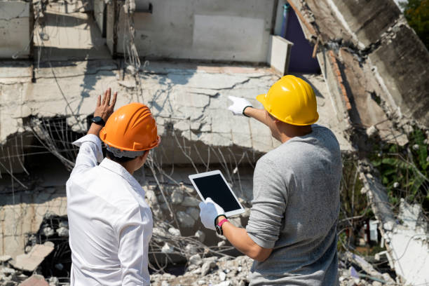 Demolition control supervisor and foreman discussing on demolish building. stock photo