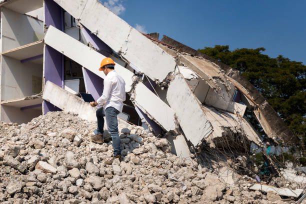 istock Engineer holding laptop is checking for destruction, demolishing building. 1205303099