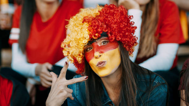 istock German soccer supporter in stadium with victory sign 1205303251
