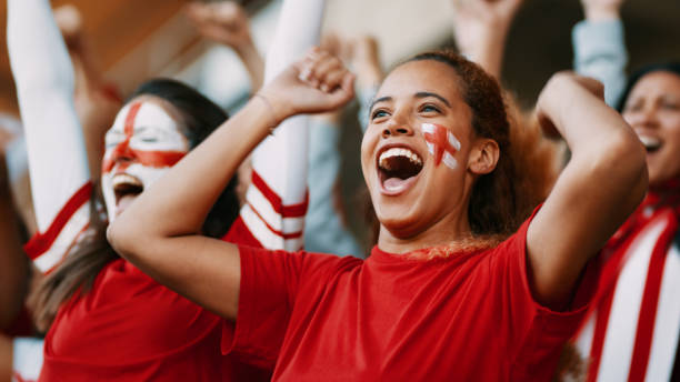 istock English female spectators enjoying after a win at stadium 1205303365