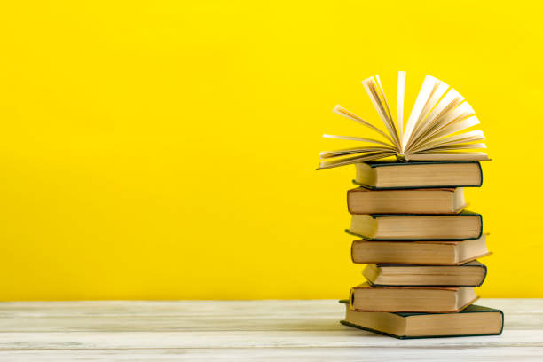 istock Open book, hardback books on wooden table. Back to school. Copy space. 1205303613