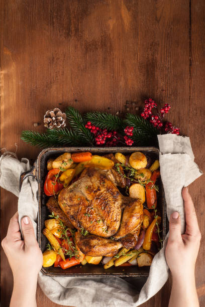 istock Baked whole chicken with vegetables. Table setting with Christmas decorations. Rustic style. 1205303828