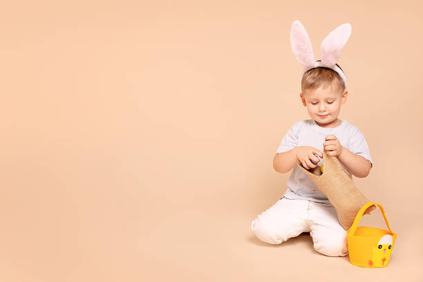 istock Little boy kid wearing easter bunny ears 1205303831