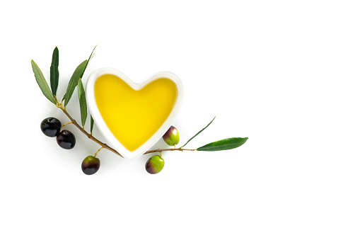 Olive oil heart shape bowl as heart healthy food on white background