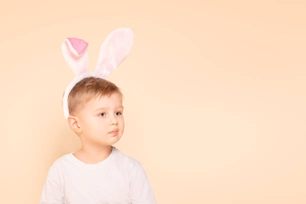 istock Little boy kid wearing easter bunny ears 1205304315