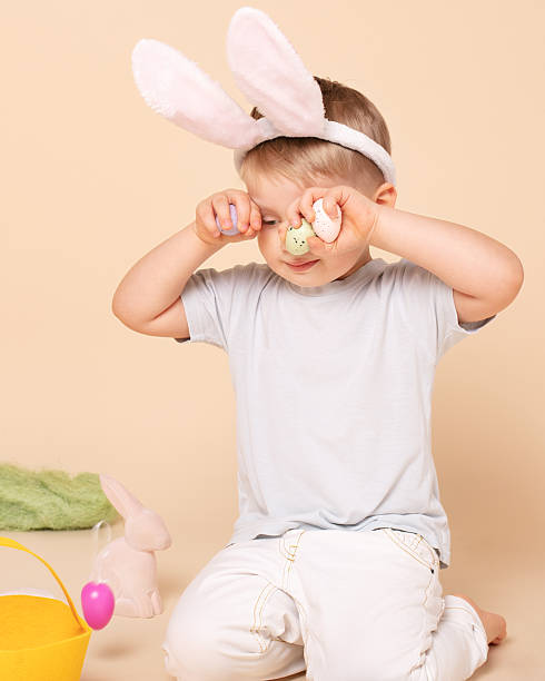 istock Caucasian tired little boy as an Easter bunny. 1205304545