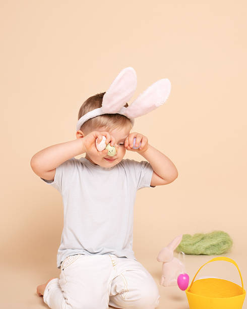 istock Caucasian tired little boy as an Easter bunny. 1205304604