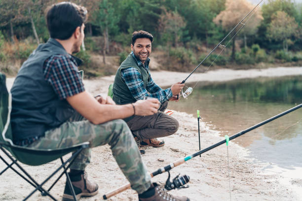 istock Two men fishing and talking 1205306637