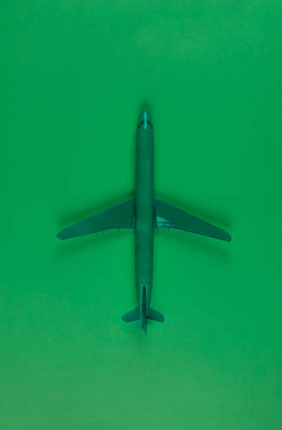 istock green airplane model isolated on green background 1205308059