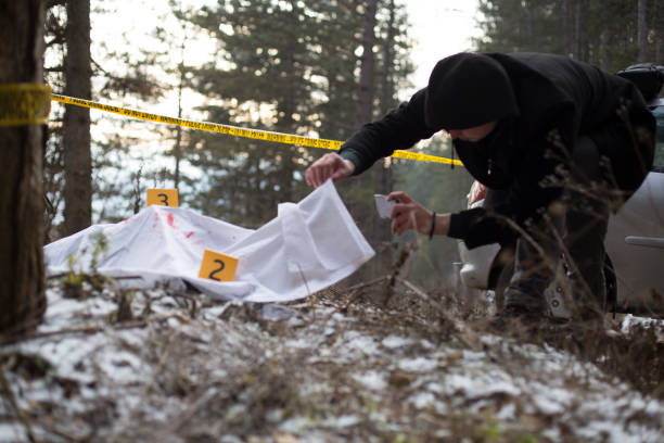 istock Detectives on murder crime scene collecting evidence 1205308062