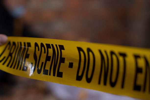 istock Detectives on murder crime scene collecting evidence 1205308234