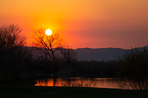 Sunset over pond and mountains in Beaumont, California