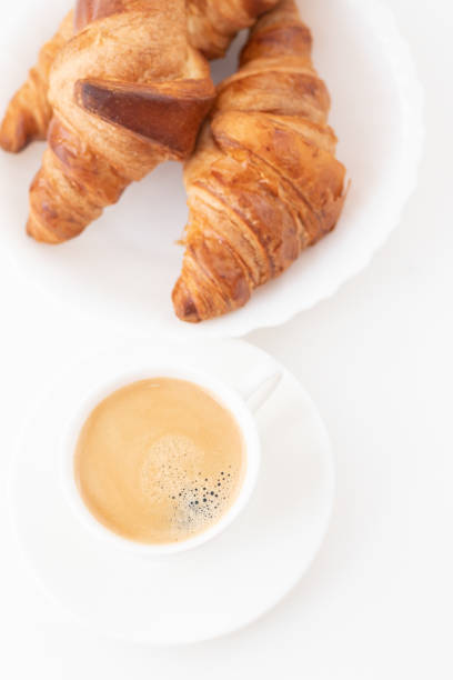 istock Tasty breakfast. Croissants and coffee on the table. Top view. 1205310540