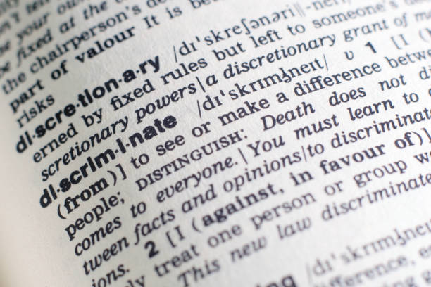 istock A close-up on a word Discriminate in English dictionary (selective focus) 1205311066