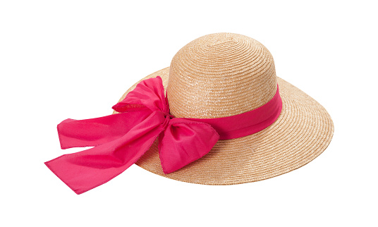 Pretty straw hat with ribbon and bow on white background. Beach hat top view isolated on white background.