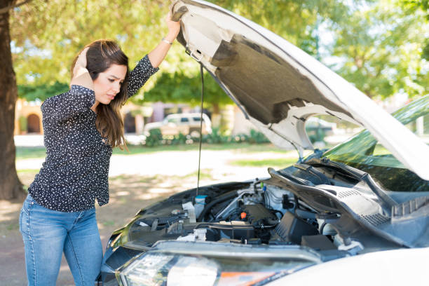 istock Woman In Despair Looking At Broken Car 1205312713