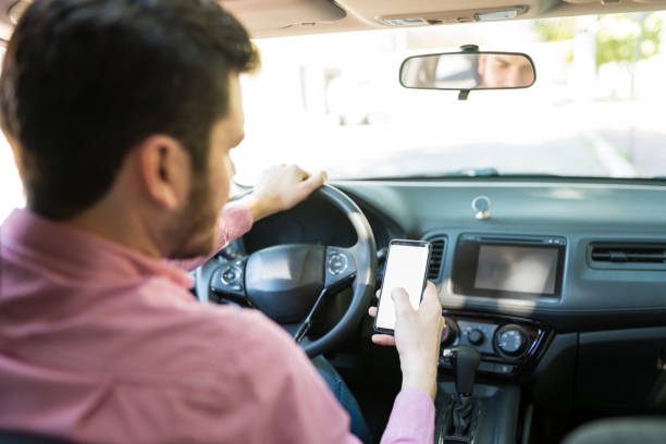 istock Man Messaging On Mobile Phone In Car 1205313041