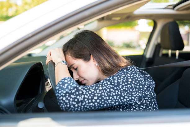 istock Annoyed Woman In Car At Traffic 1205313380
