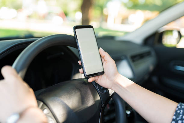 istock Woman Holding Mobile Phone In Car 1205313627