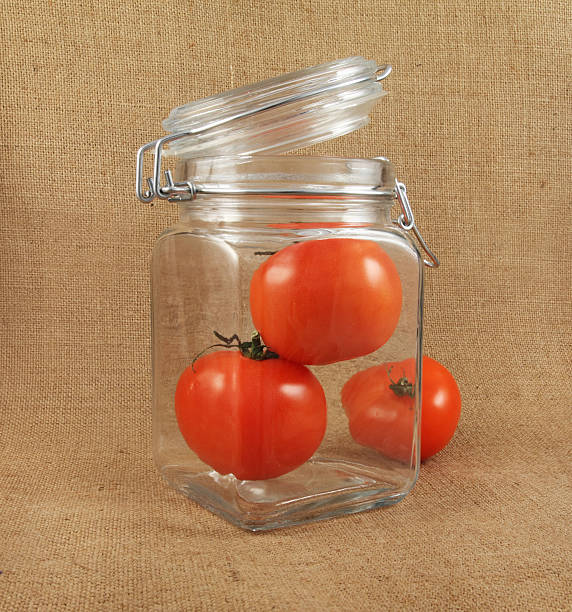 tomatoes in jar stock photo
