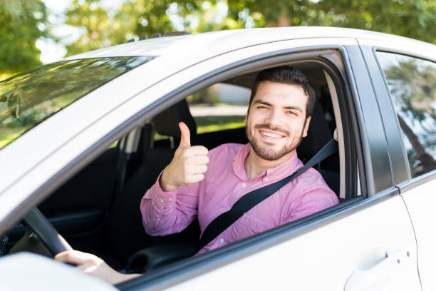 istock Man In New Car Showing Thumbs Up 1205314361