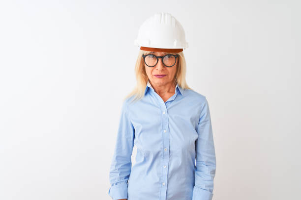 istock Middle age architect woman wearing glasses and helmet over isolated white background depressed and worry for distress, crying angry and afraid. Sad expression. 1205314452