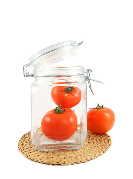 tomatoes in jar stock photo