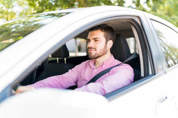 istock Hispanic Adult Man Driving New Car 1205314807