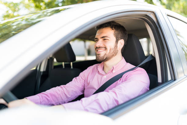 istock Smiling Man Enjoying Car Ride 1205314920