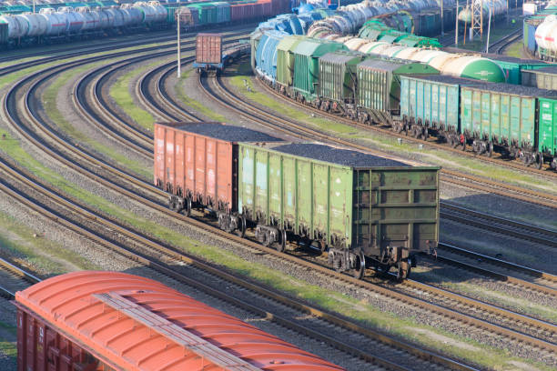 istock Cars with coal at railway station 1205315101