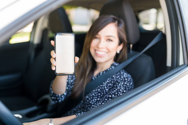istock Happy Woman With Smartphone In Car 1205315221