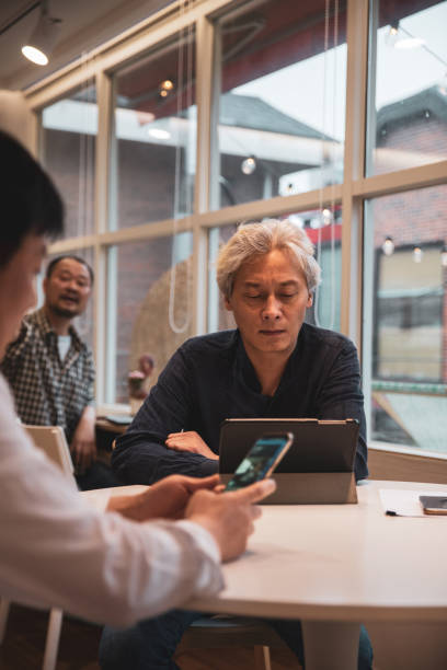 istock Mature adult men working on a project together 1205315318