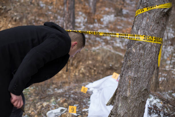 istock Detectives on murder crime scene collecting evidence 1205316744