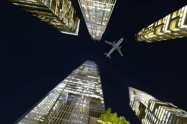 istock Airplane flying over New York City at night 1205317525