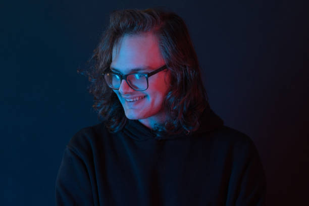 istock Portrait of smiling young man on neon colored 1205317626