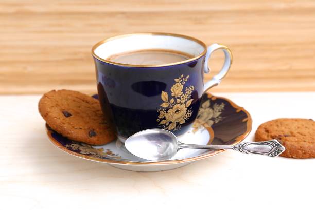 istock Coffee with milk in a cup, teaspoon of silver and cookies 1205317683