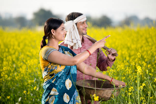 istock Rural Indian couple in rapeseed field 1205319588