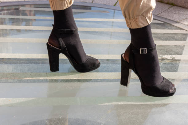 istock Close-up on womens legs on high heels 1205321935