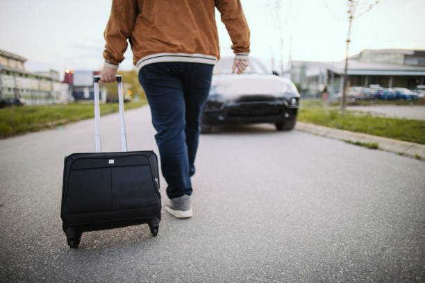 istock Man with suitcase is walking on the street 1205323404